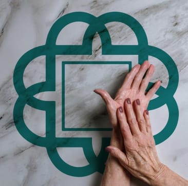 Hands over marble with Queen Square logo